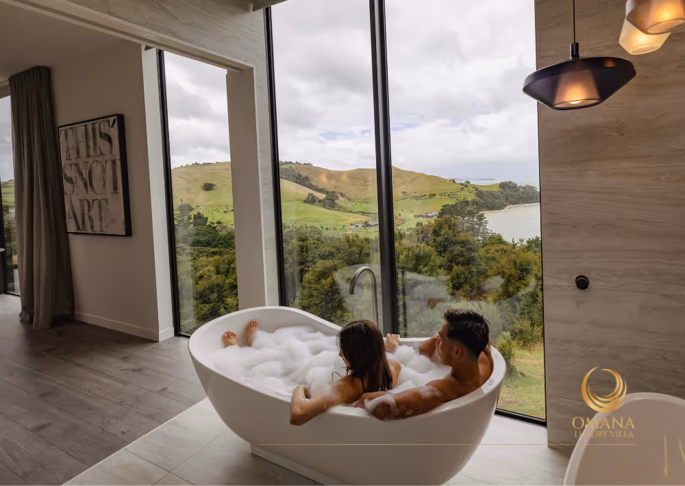 A couple having a relaxing time in the bathtub with an ocean view