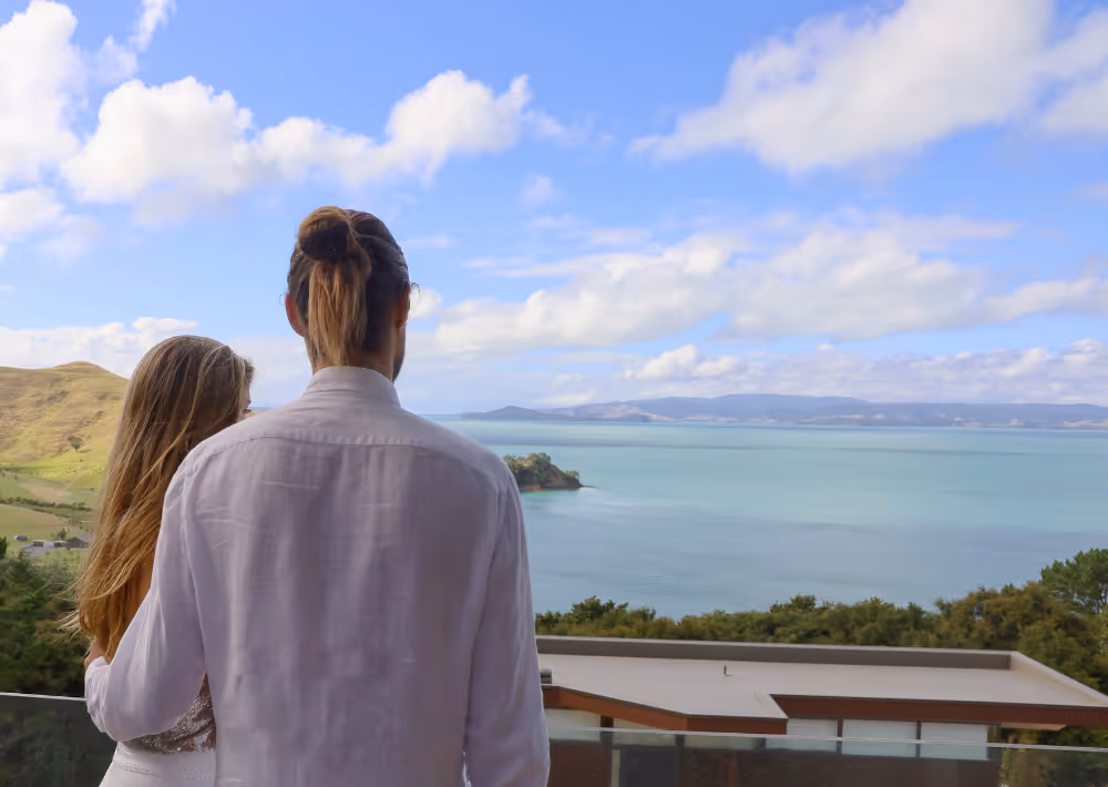 A couple marvelling at the ocean view from the balcony