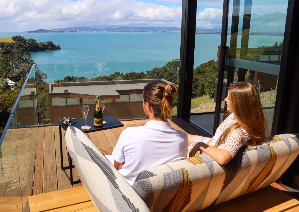 A couple relaxes on the balcony of Villa Serenity