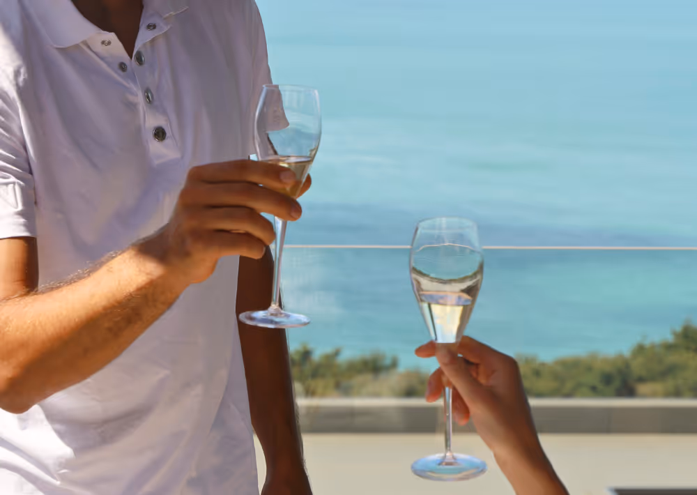 A couple toasting on the balcony