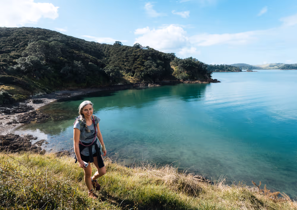 A woman on a hiking along the sea on Waiheke Island
