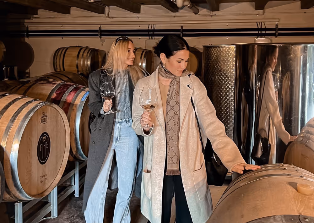 Two beautiful women enjoy a wine-tasting experience