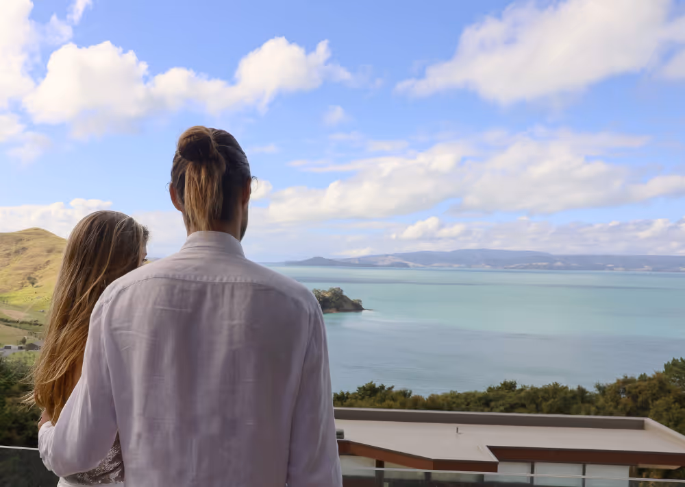 A couple marvels at the ocean view from Villa Serenity's balcony