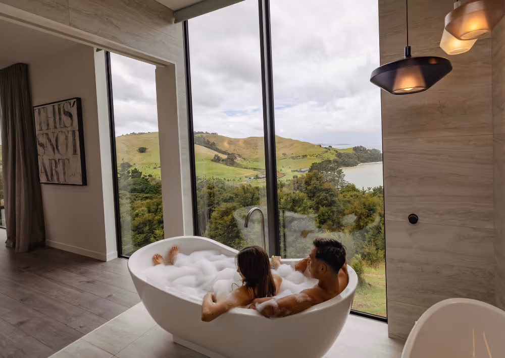 A couple share a bathtub and marvel at the Waiheke Island view