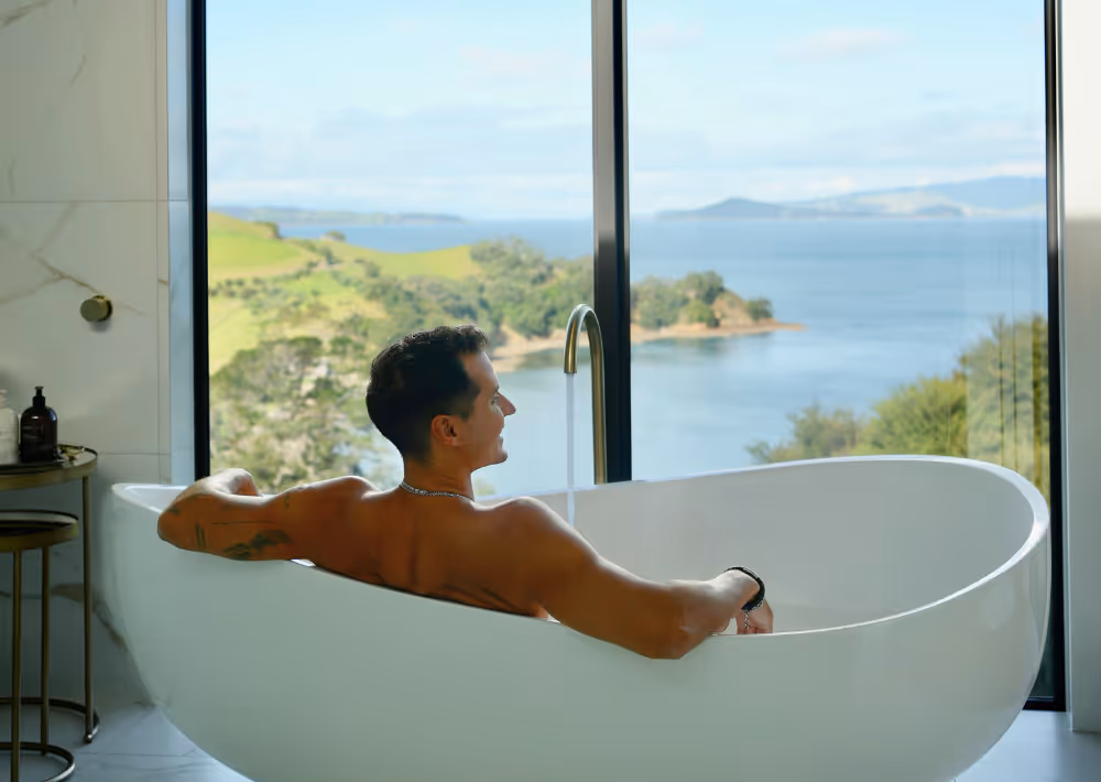 A gentleman relaxes in the bathtub at Omana boutique hotel, on Waiheke Island