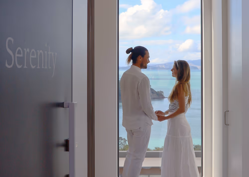 A couple by Villa Serenity's door and the ocean as the backdrop