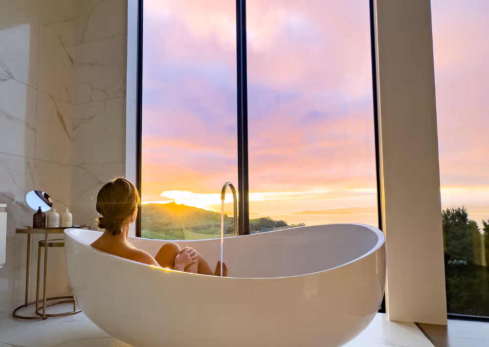 A guest at Villa Haven's bathtub marvels at the sunset