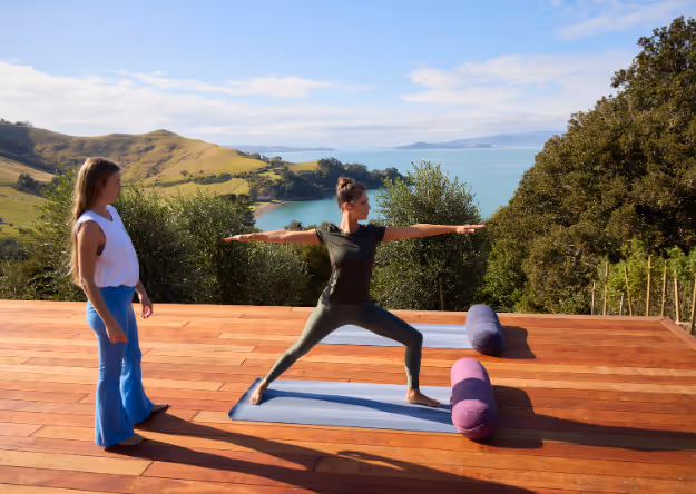 Omana guest during a yoga session with the ocean as the backdrop