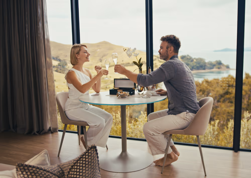 A couple toasts and has caviar in Omana's villa