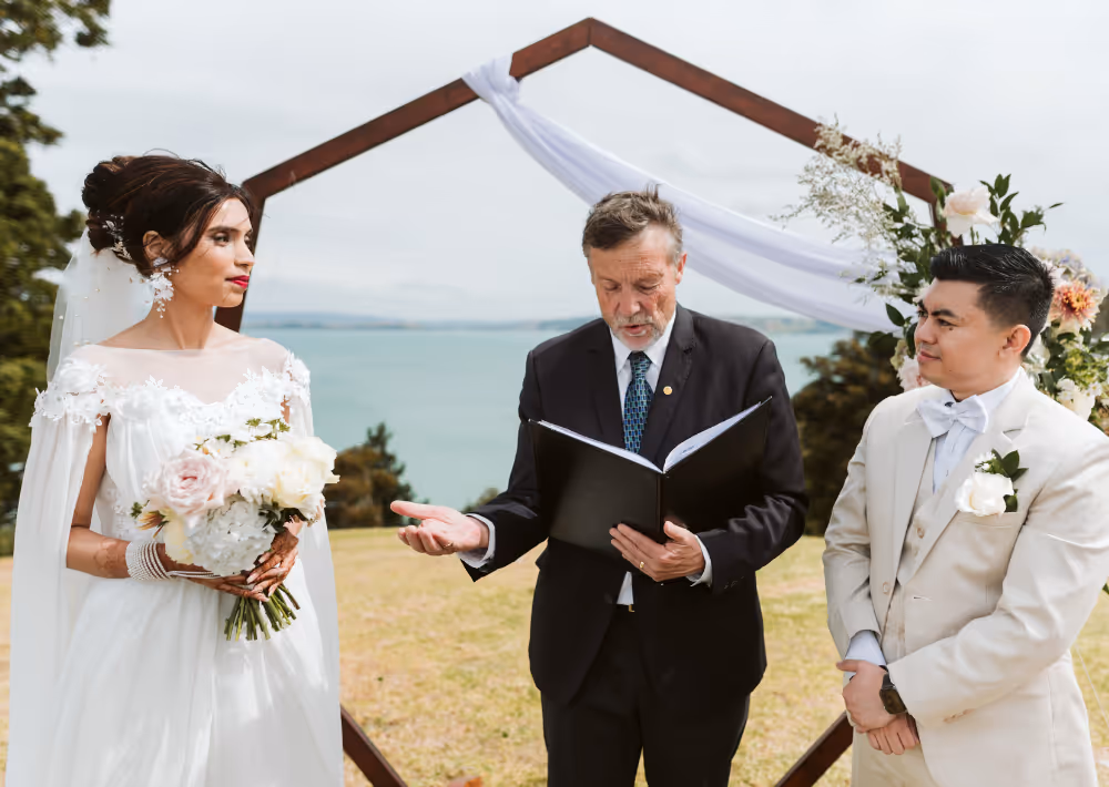 A couple getting married at Omana with the ocean as the backdrop