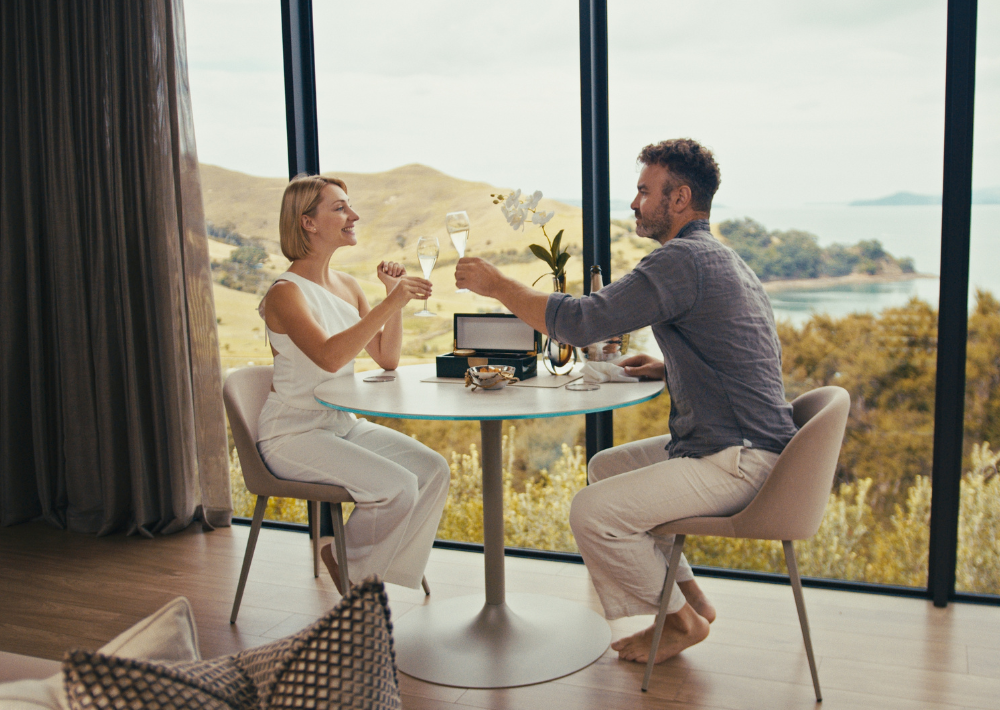 A couple having sparkling wine and caviar at Omana's luxury villa 