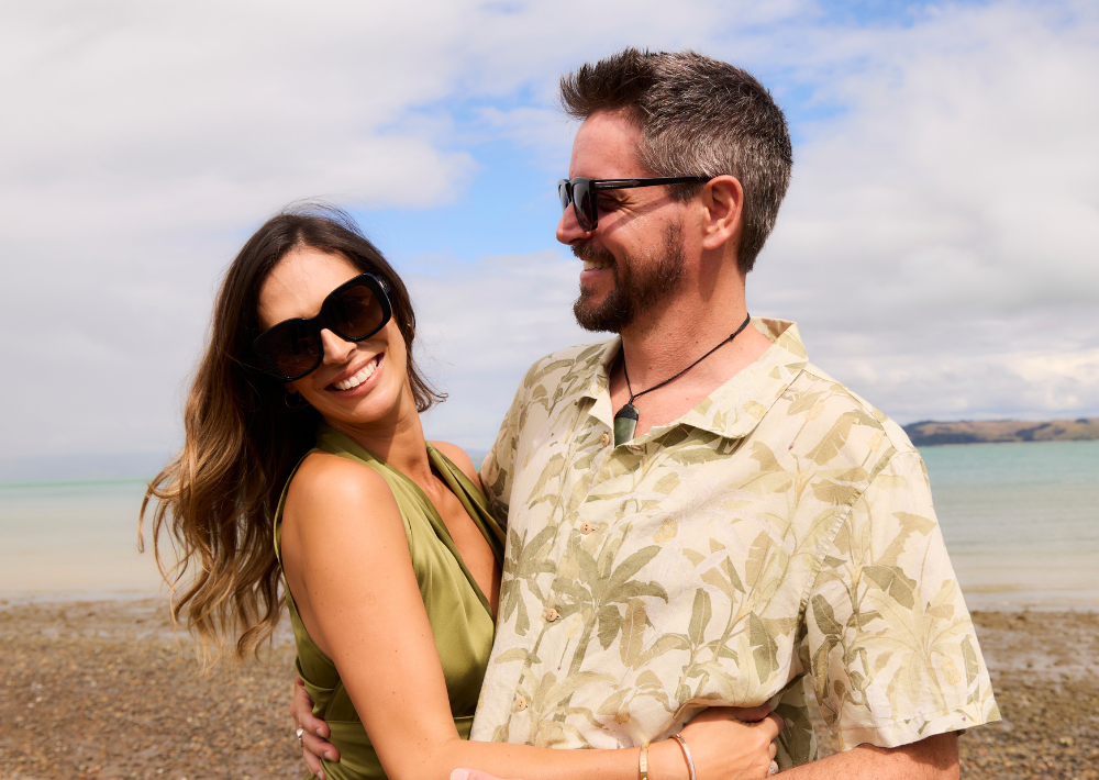 A couple staying at Omana enjoys the local private beach on Waiheke Island