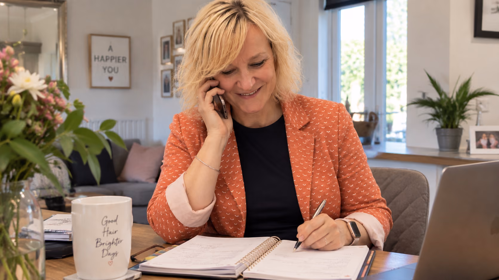 Alison taking a call from a client booking a hair appointment