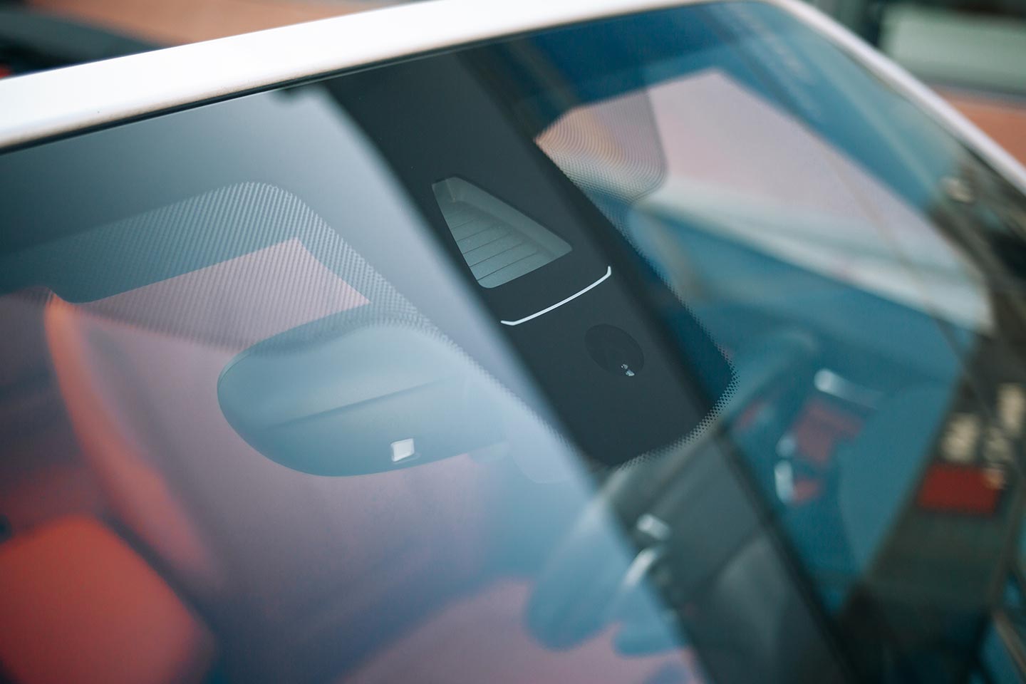 A front windscreen of a performance car that has window protection and tinting applied to it