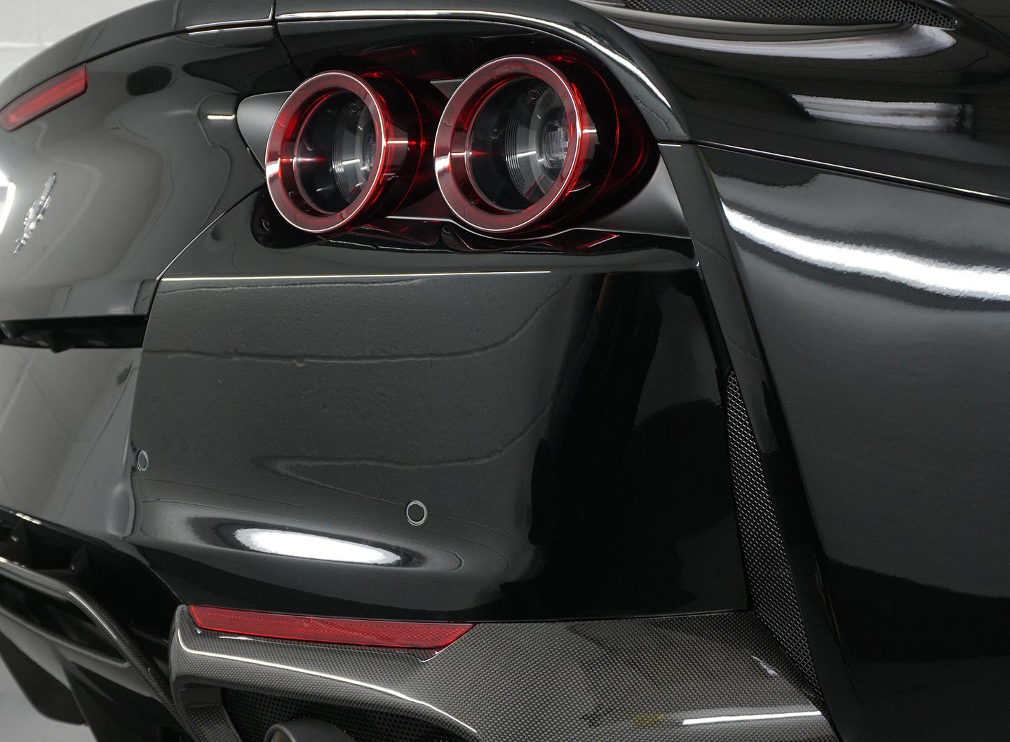 The rear of a supercar that has paint protection film perfectly applied to it