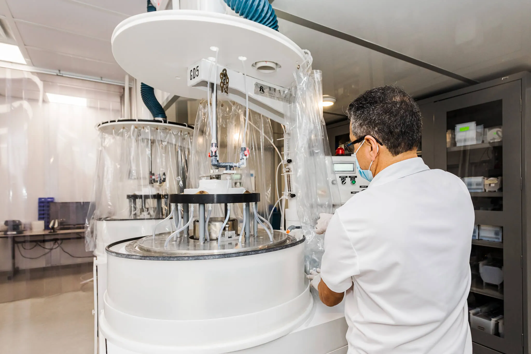 Employee manufacturing a silicon wafer. 