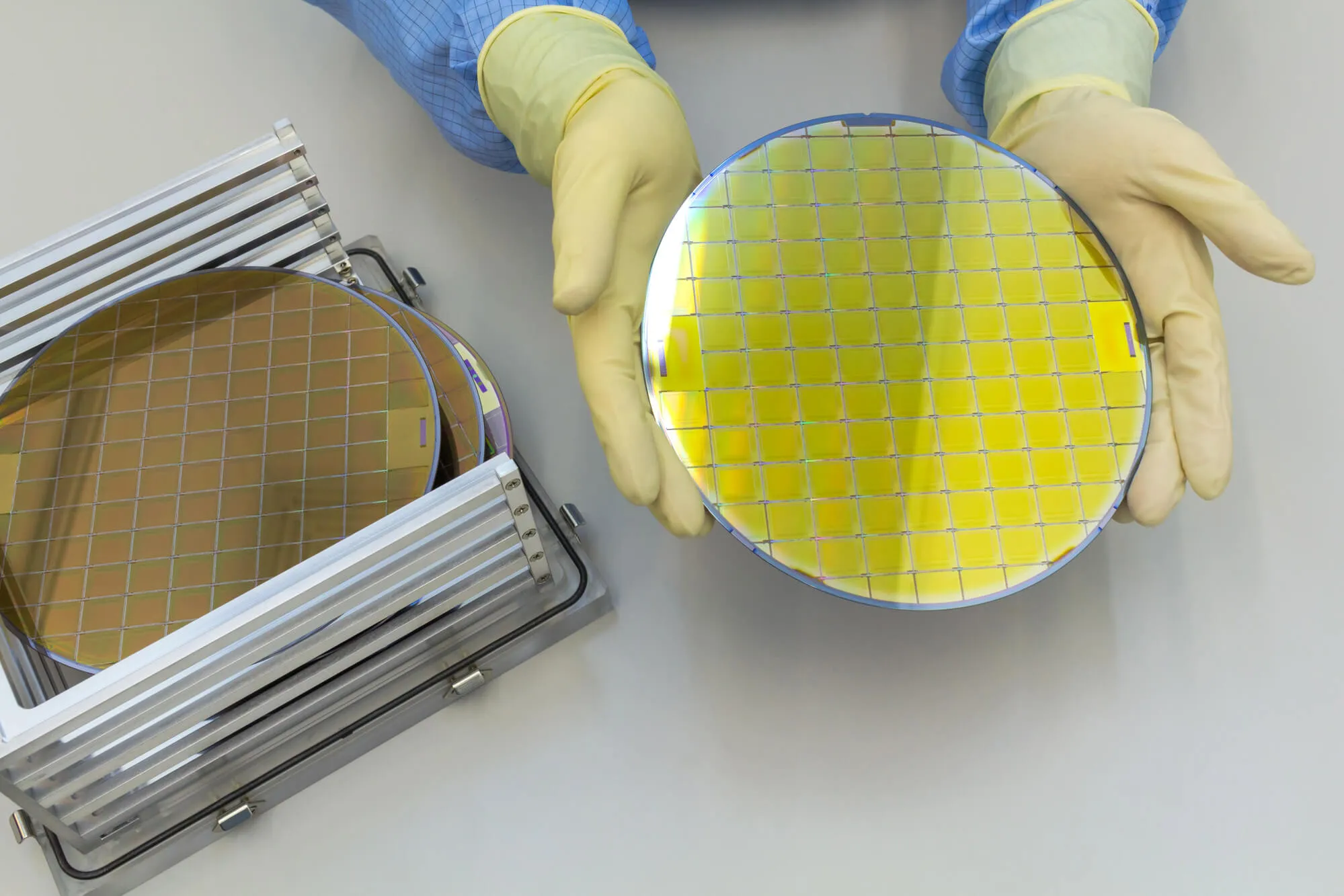 Worker showing wafer after manufacturing
