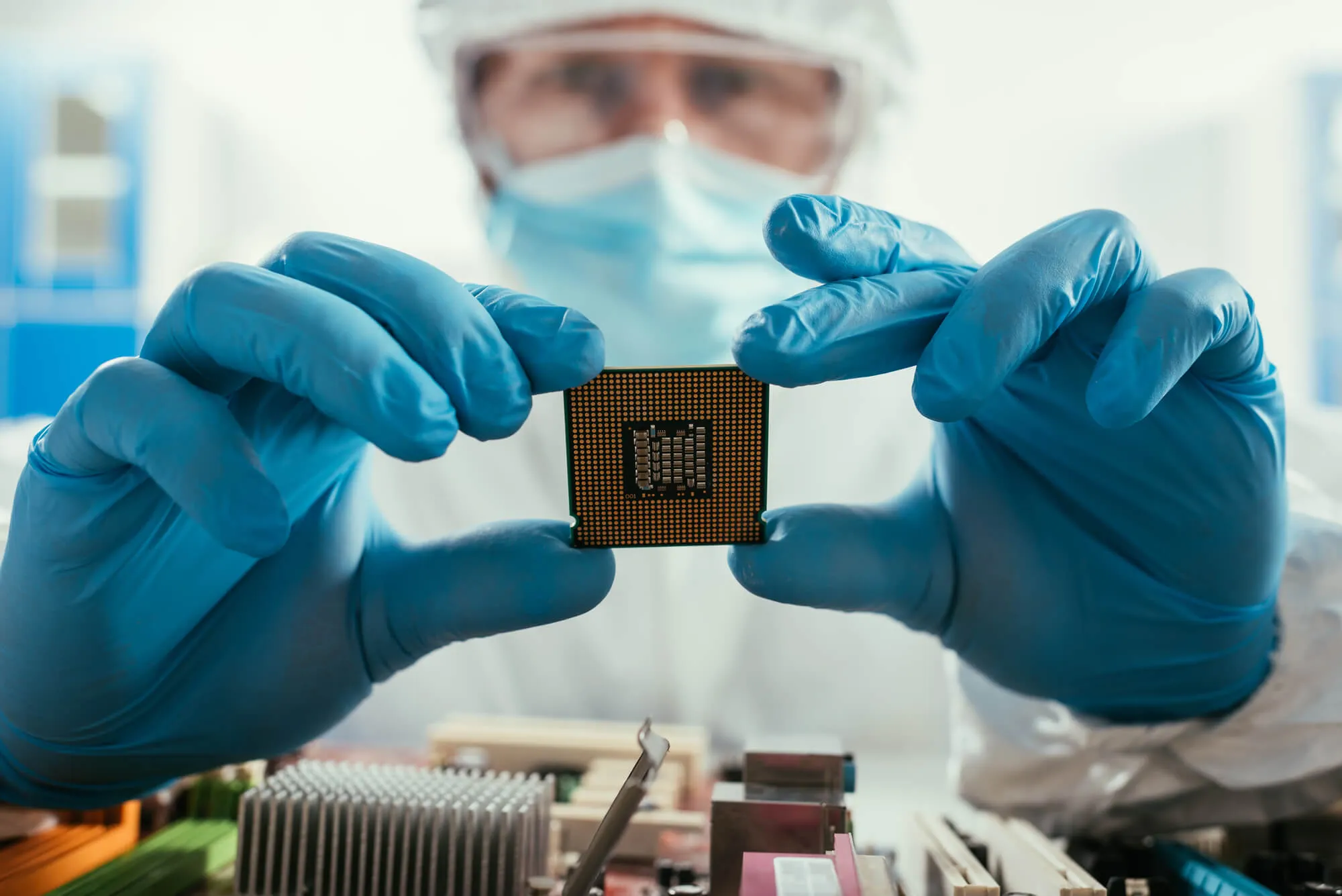  Engineer holding a microchip after contactings silicon wafer suppliers  