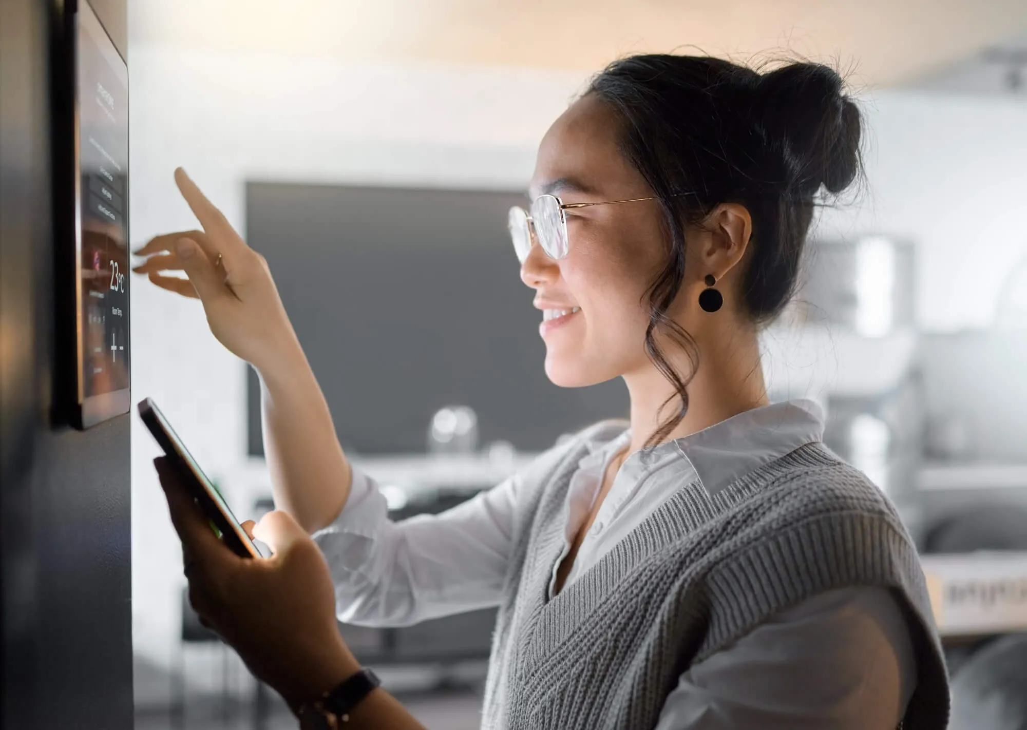 Woman looking at a room's control panel