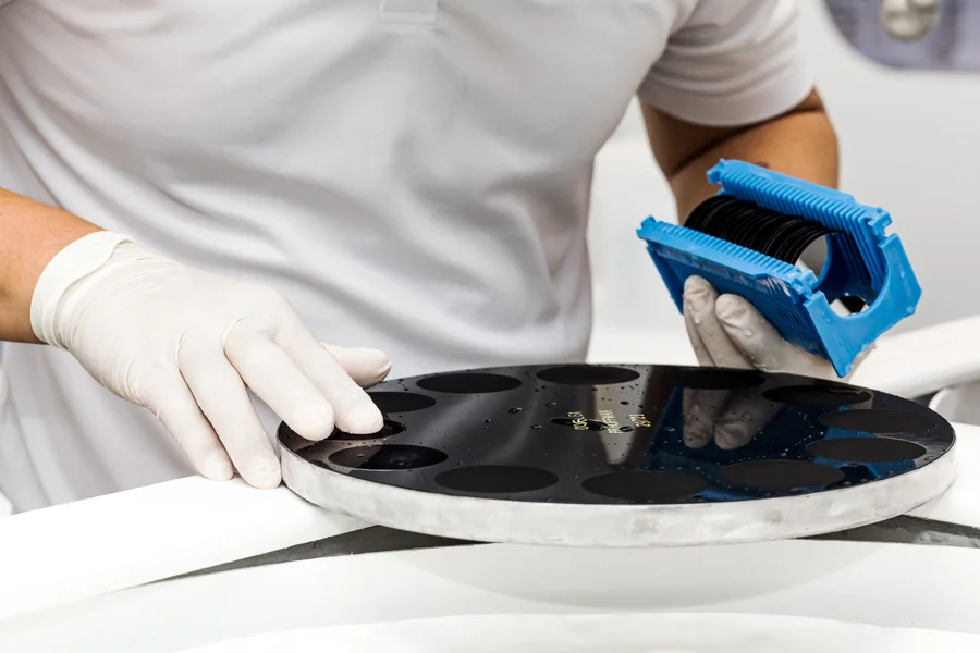 silicon-wafer-processing-technician-handling-wafers-in-blue-carrier