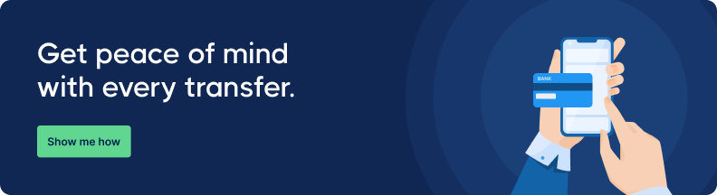 Illustration of a hand holding a smartphone with a bank app on screen. Text reads, 'Get peace of mind with every transfer.' Button says, 'Show me how.'