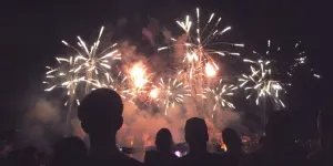Crowd watching colorful fireworks at night