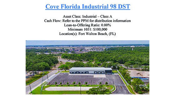 Industrial property with a large warehouse and empty parking lot surrounded by trees in Fort Walton Beach, Florida.