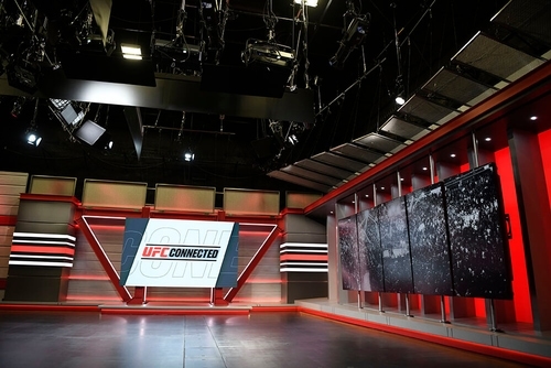 Stage B at UFC Apex showing a large screen and red wall panels