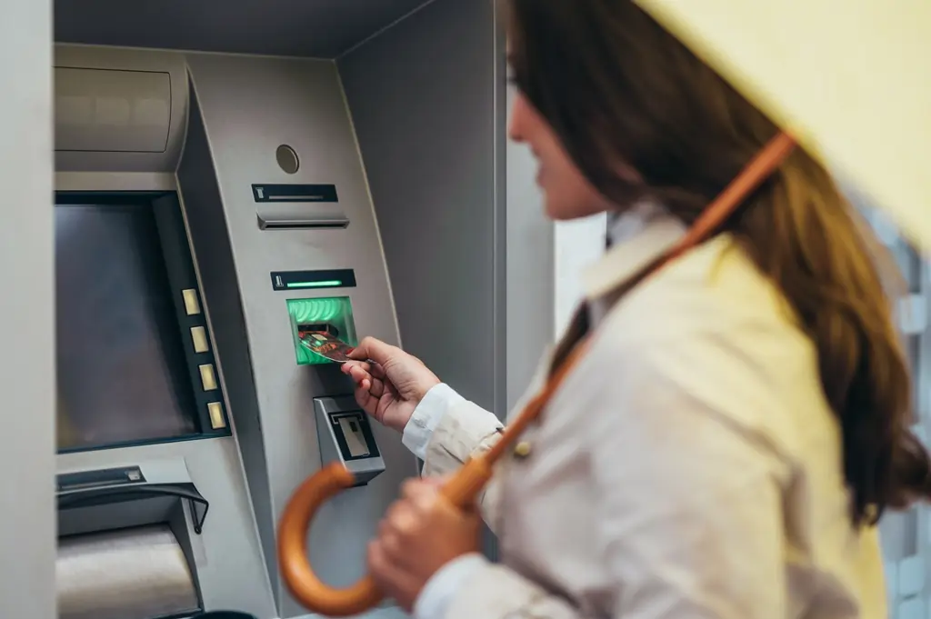 woman bank atm machine