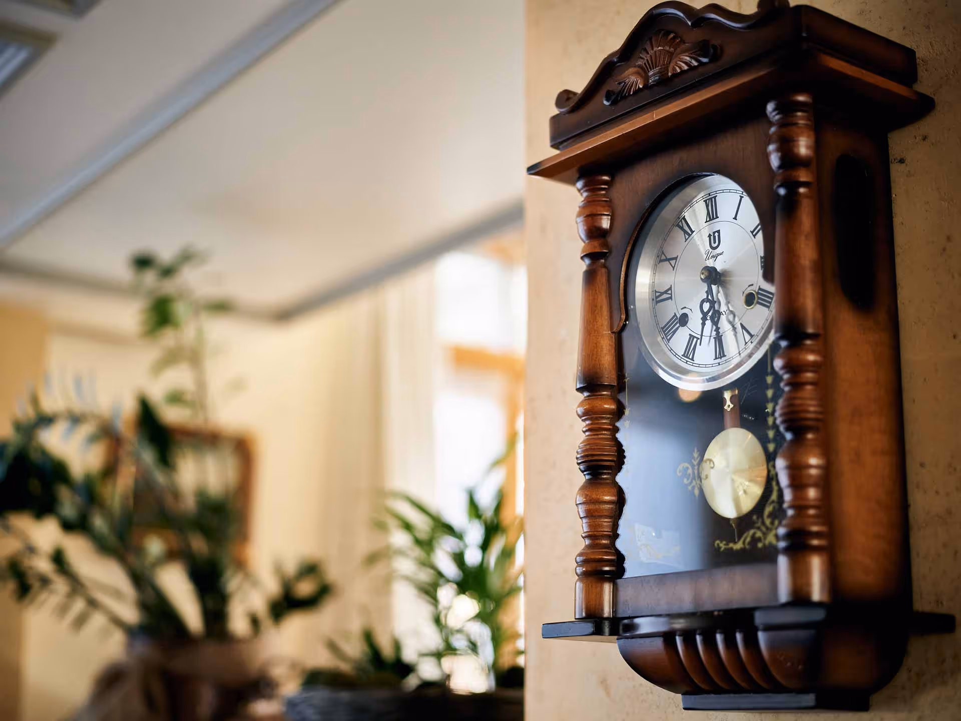 Old wall clock on orange wallpaper