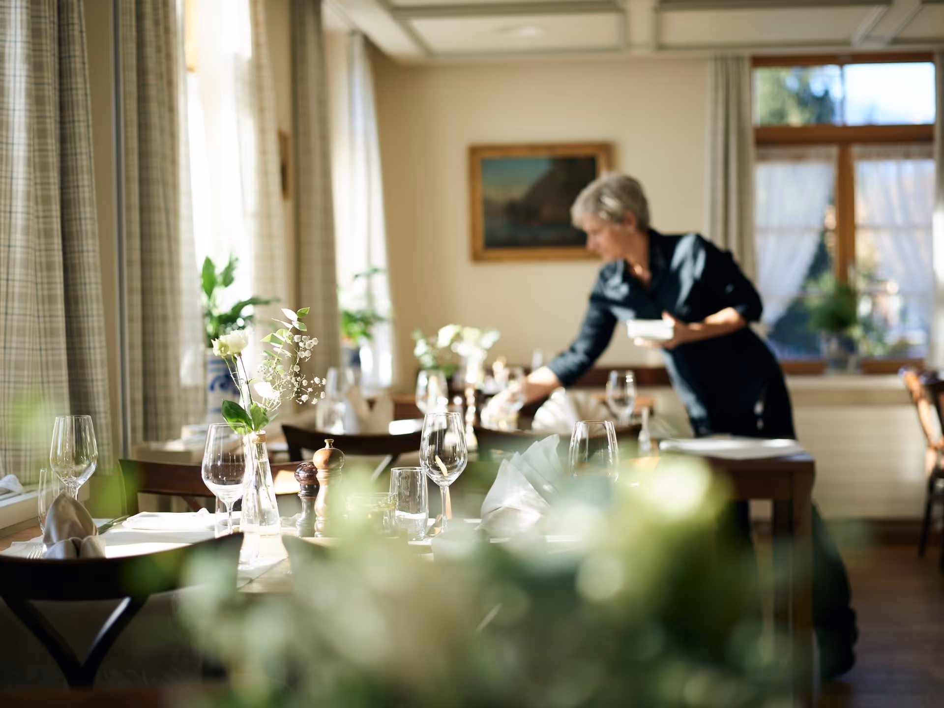 Frau dekoriert Tisch in Restaurant