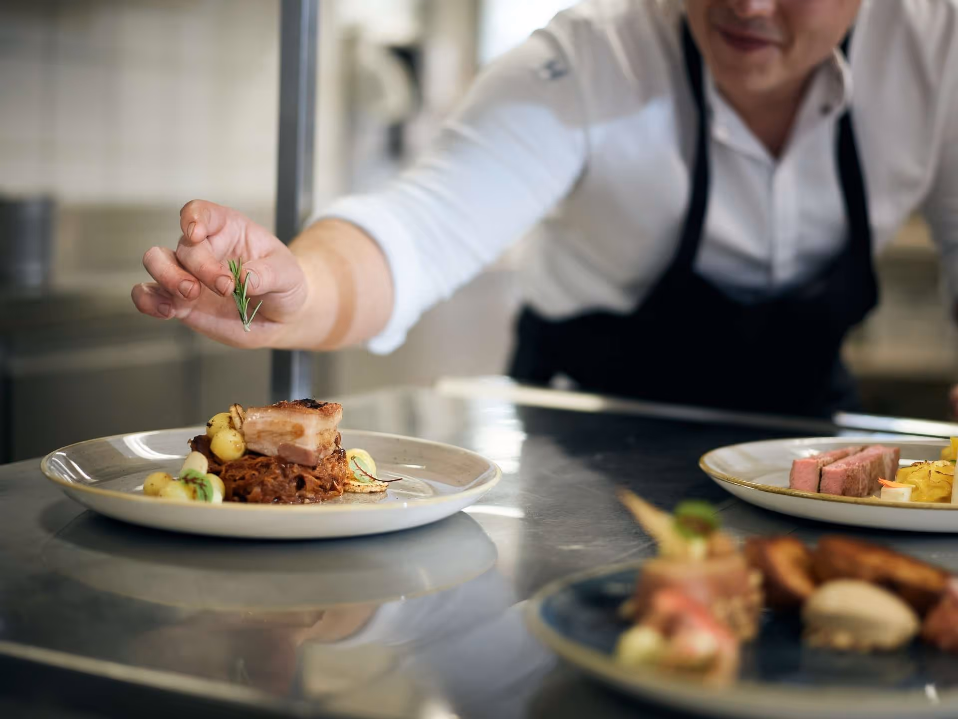 The chef plates the dish