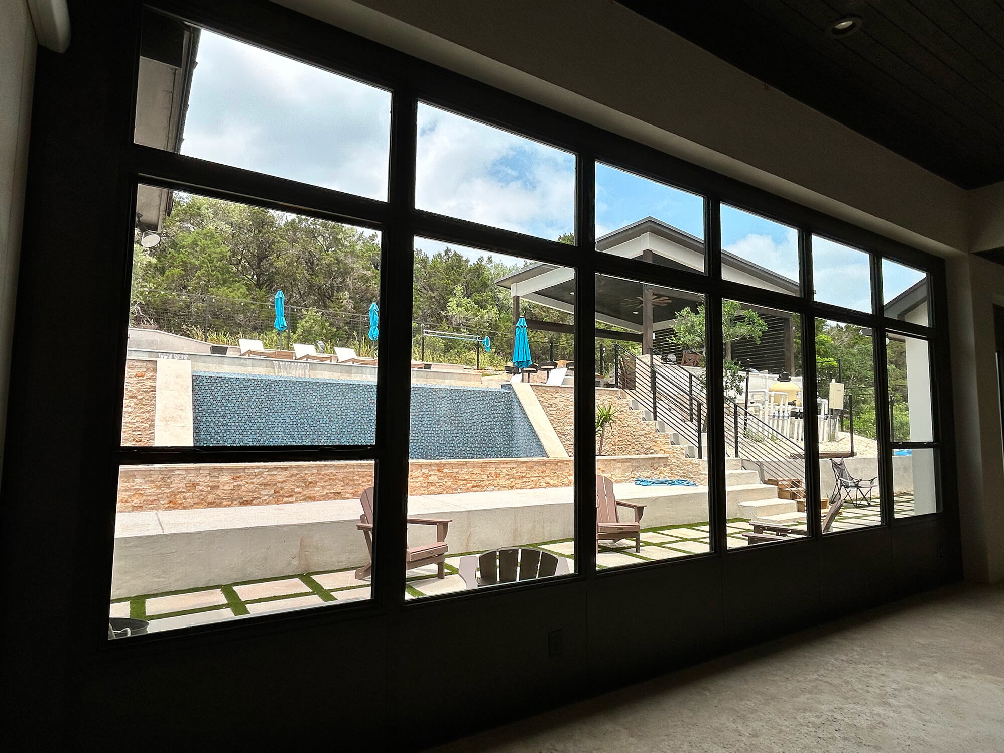 Backyard view of pool and patio lounge chairs in San Antonio.