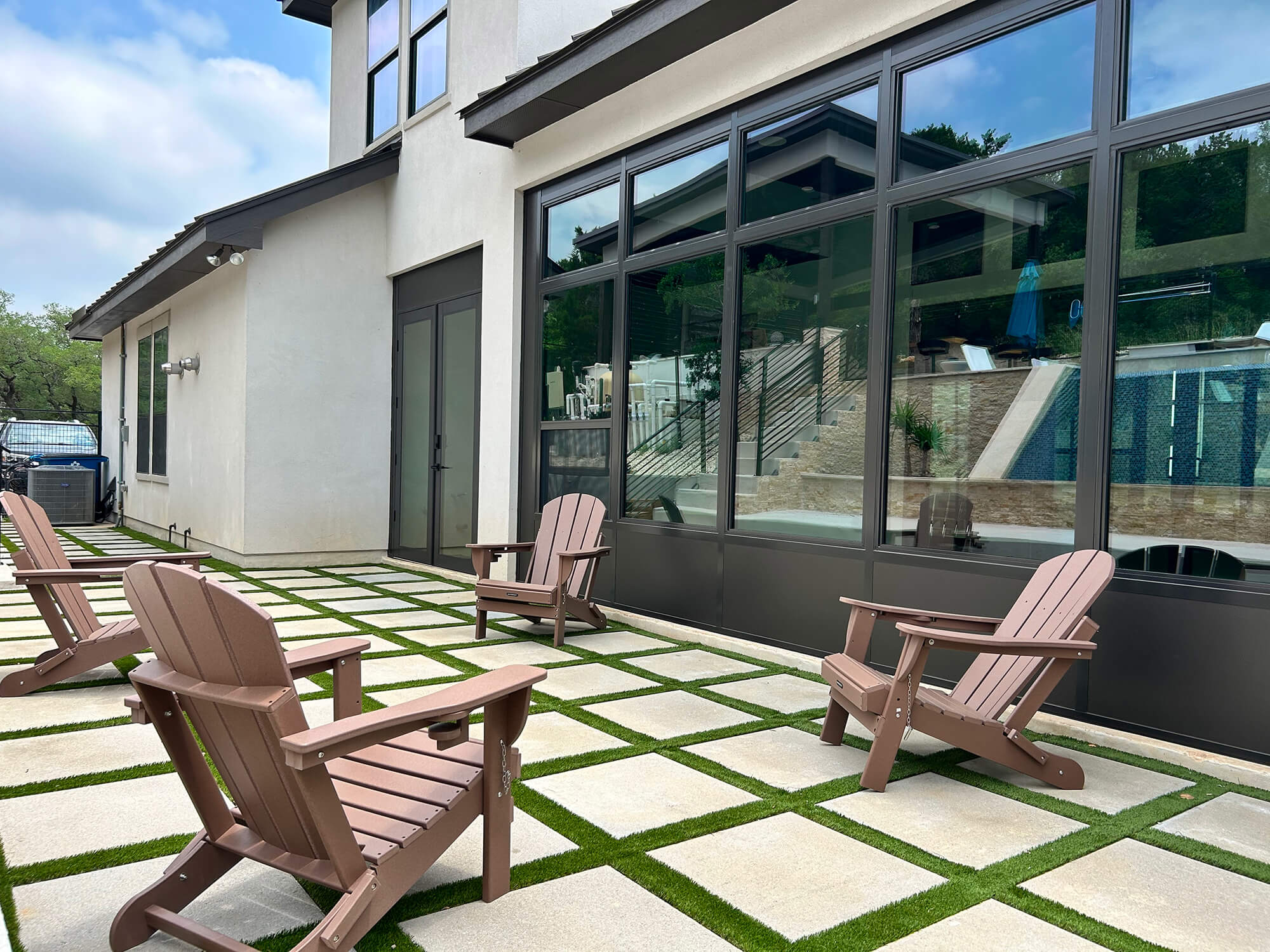 Modern San Antonio patio with Adirondack chairs.