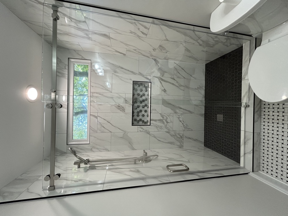 We deleted the tub in the first bath and installed a fully tiled shower with sliding glass doors. 