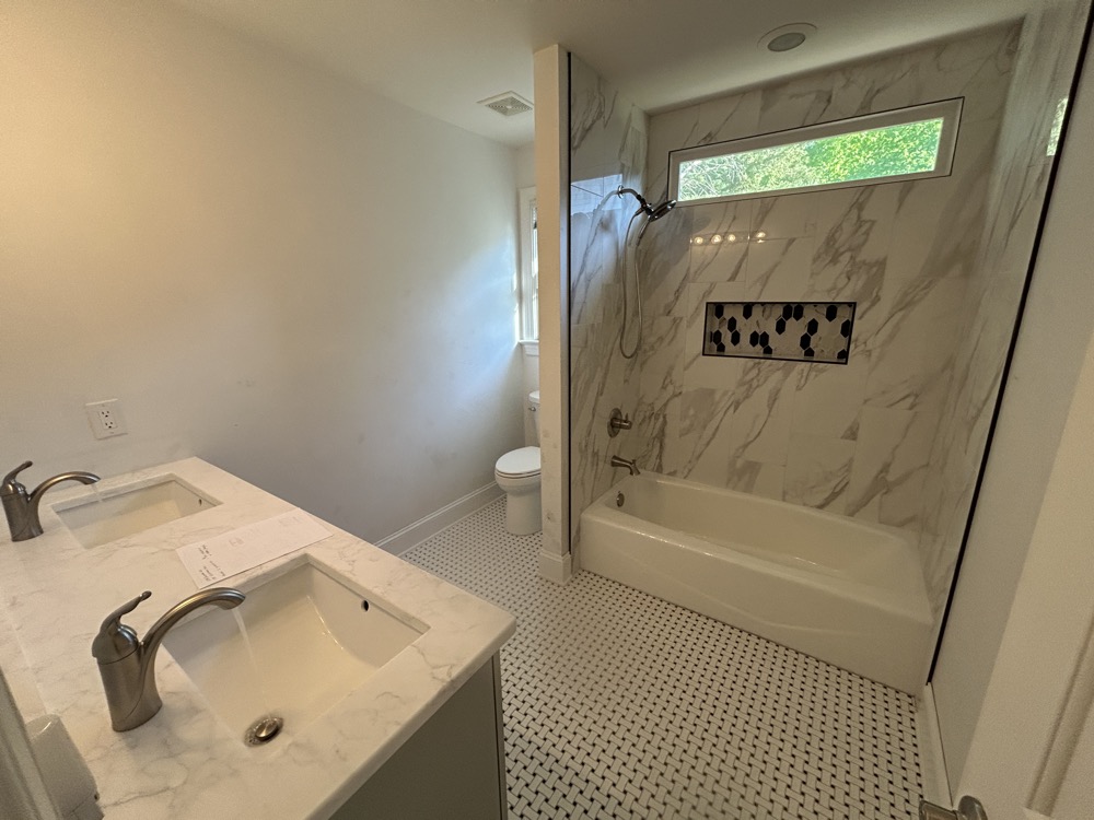 At bath 2 (below) we protected the original tub and tiled around it.