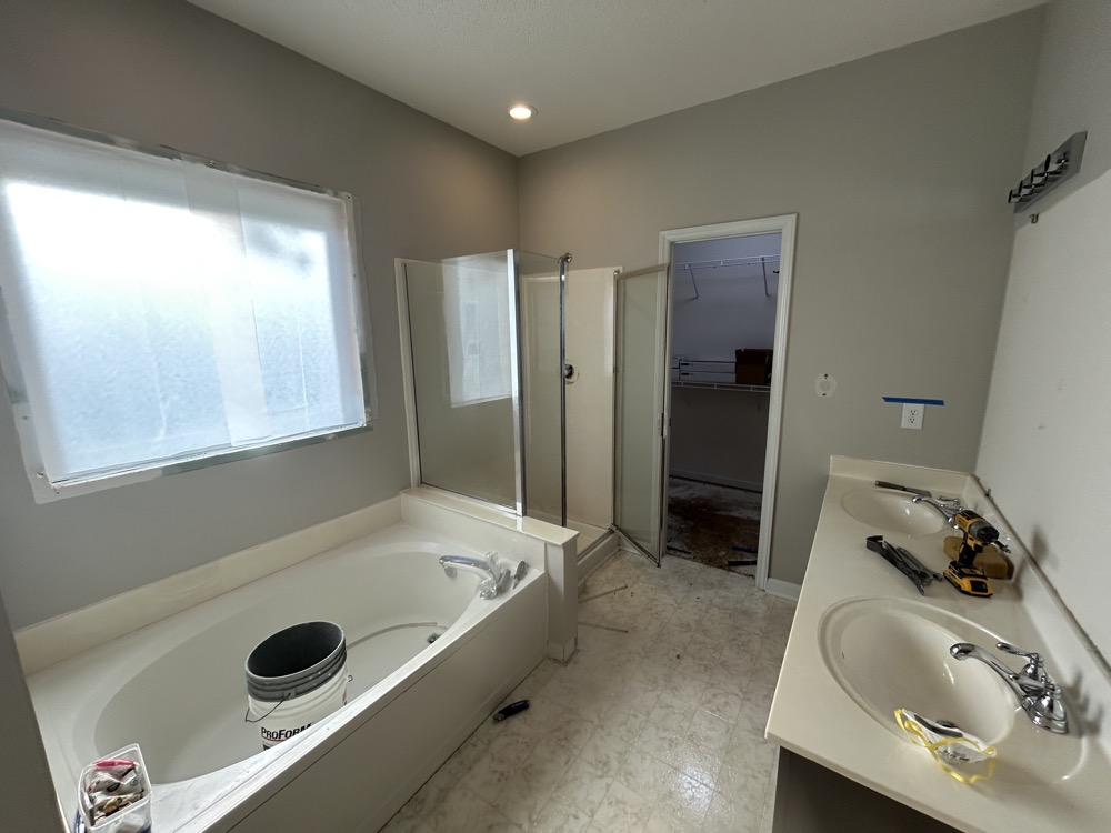 This next image is the "before". Where the tub is (under the window) is where the finished dressing desk is located.