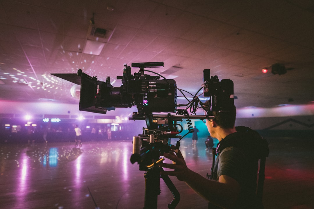 Person operating large camera in roller rink
