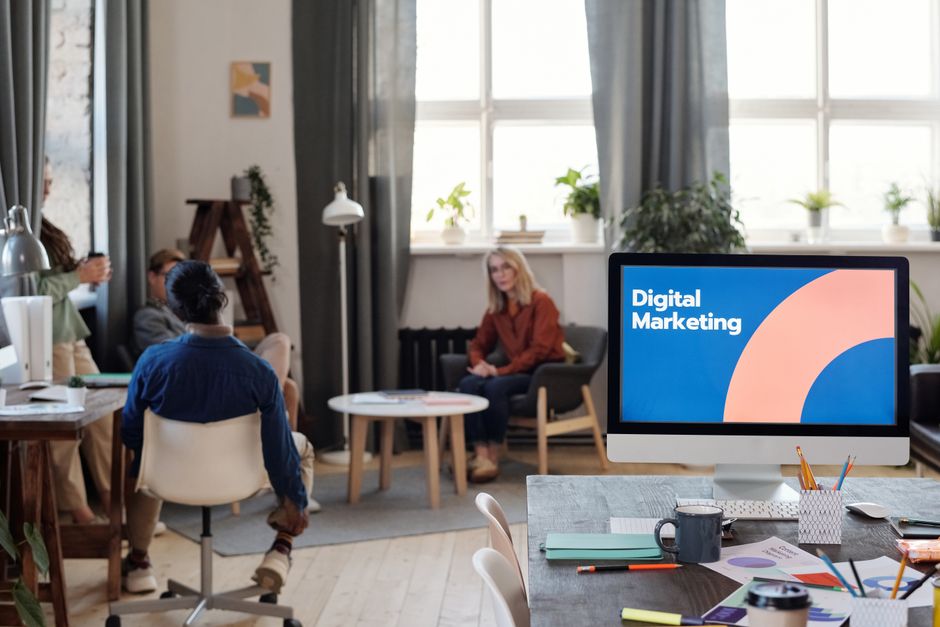 People in office with digital marketing screen