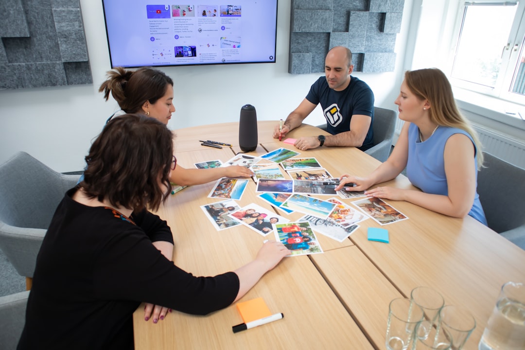 Four people discussing photos at a table