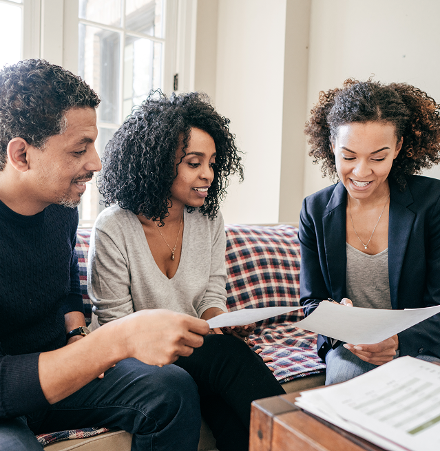 Couple meeting with a real estate agent to review home buying documents