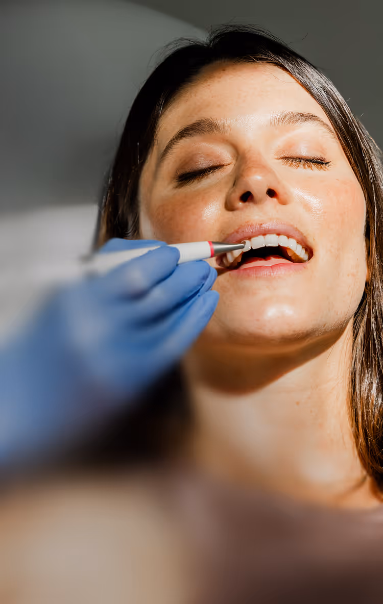 Woman smiling during a dental check-up with a dentist at Wally