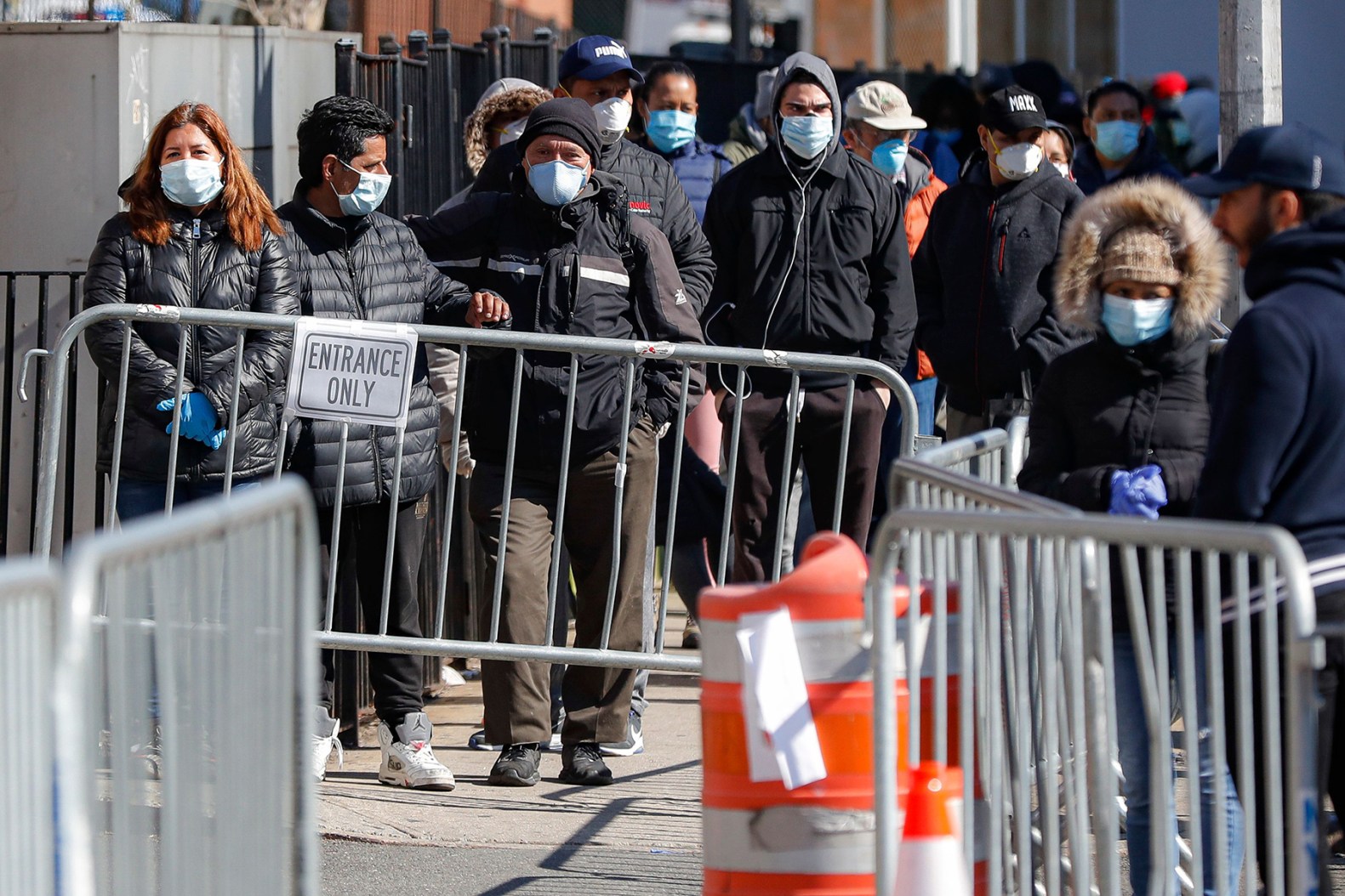 Patients wearing face masks and personal protective equipment wait on line for COVID-19 testing outside Elmhurst Hospital Center, in New York. The new coronavirus causes mild or moderate symptoms for most people, but for some, especially older adults and people with existing health problems, it can cause more severe illness or deathVirus Outbreak , New York, United States - 27 Mar 2020
