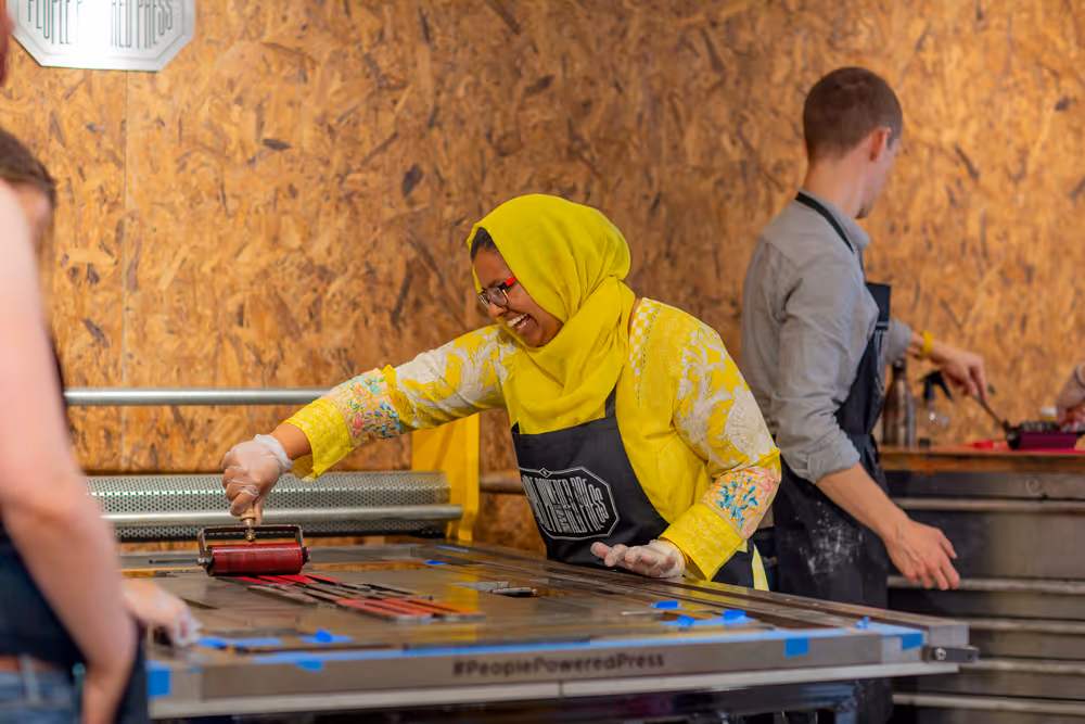 Laughing lady using the printing press
