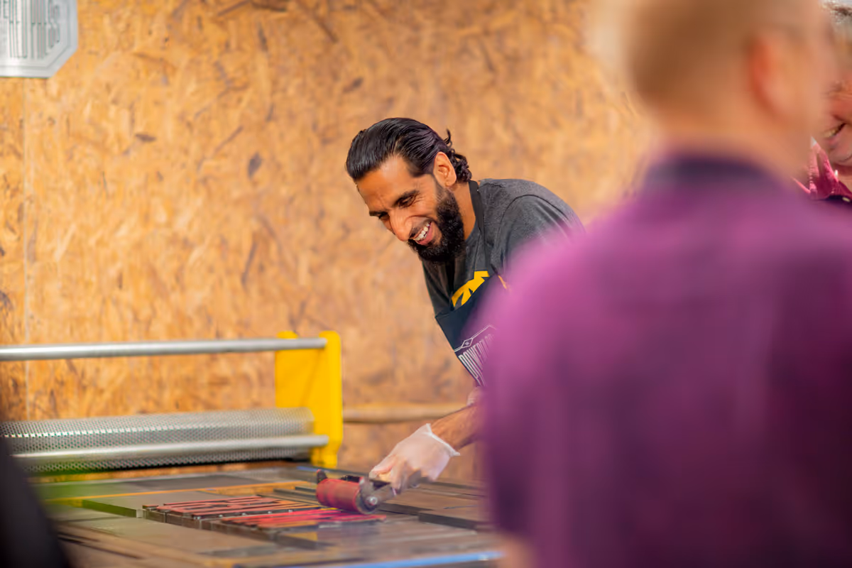 Smiling man using the printing press