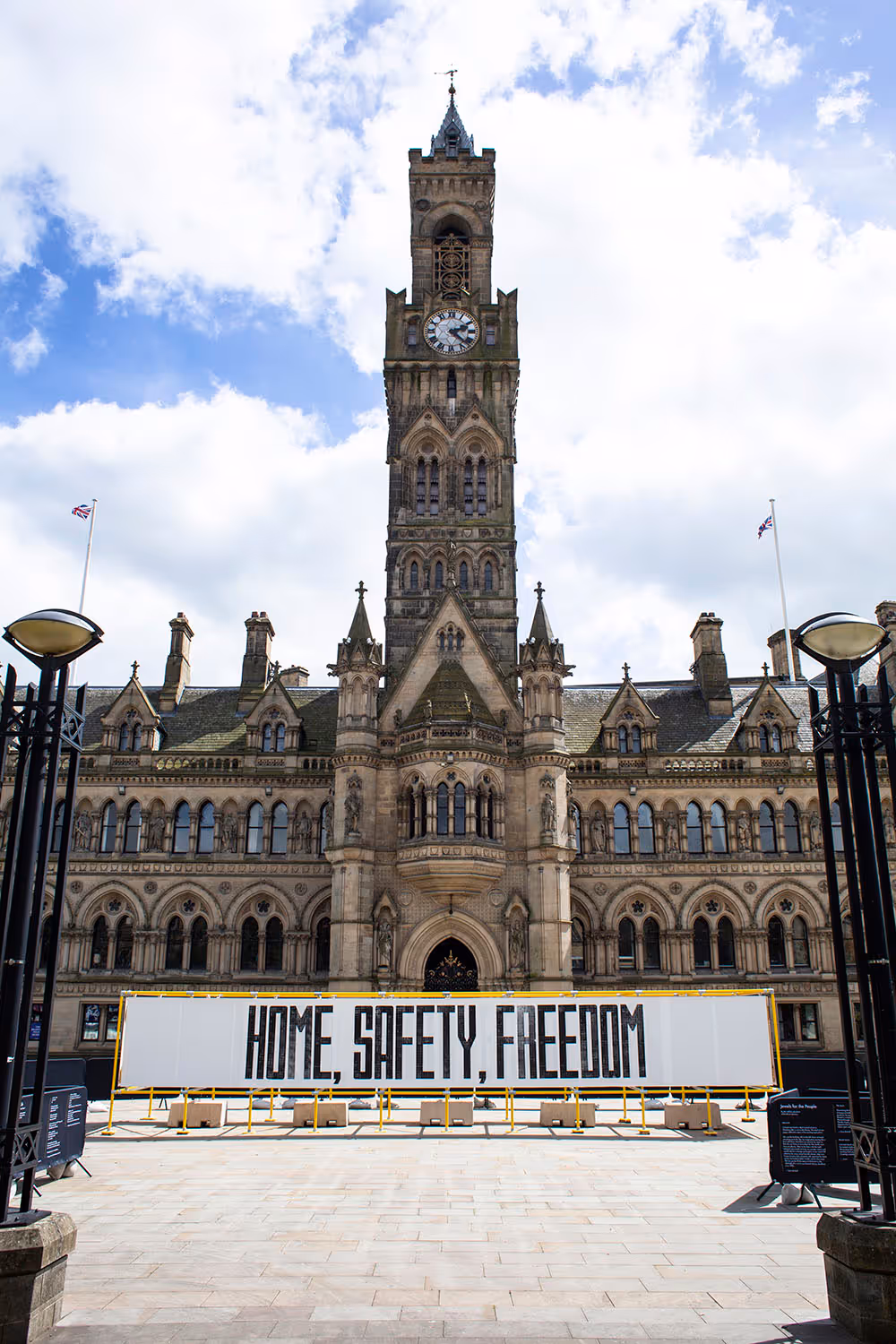 Large mural in Bradford's Centenary Square which reads, 'Home, Safety, Freedom'