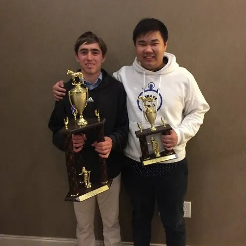 Debate Camp instructors Lucas and White take a photo with students