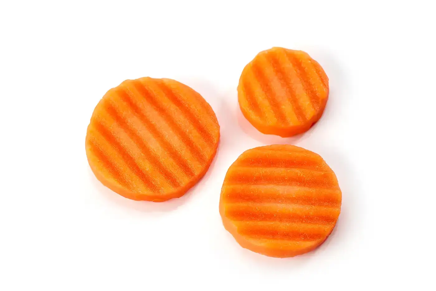 Carrot slices cut with BenchFoods 3mm ripple slicer blade showing textured wavy surface