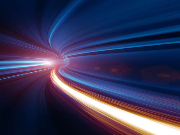 Abstract tunnel with dynamic blue and orange light streaks creating a sense of speed and motion.