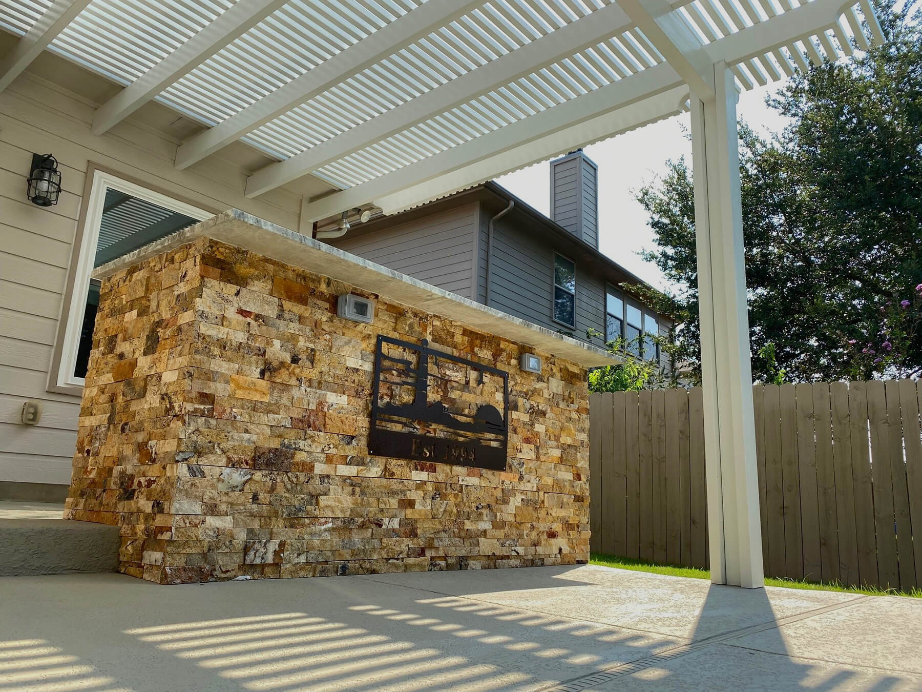 custom outdoor kitchen with multicolored brick bar